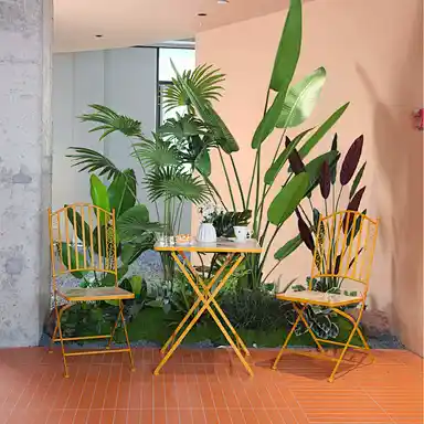 mediterranean-style mosaic bistro set in hotel courtyard with bougainvillea